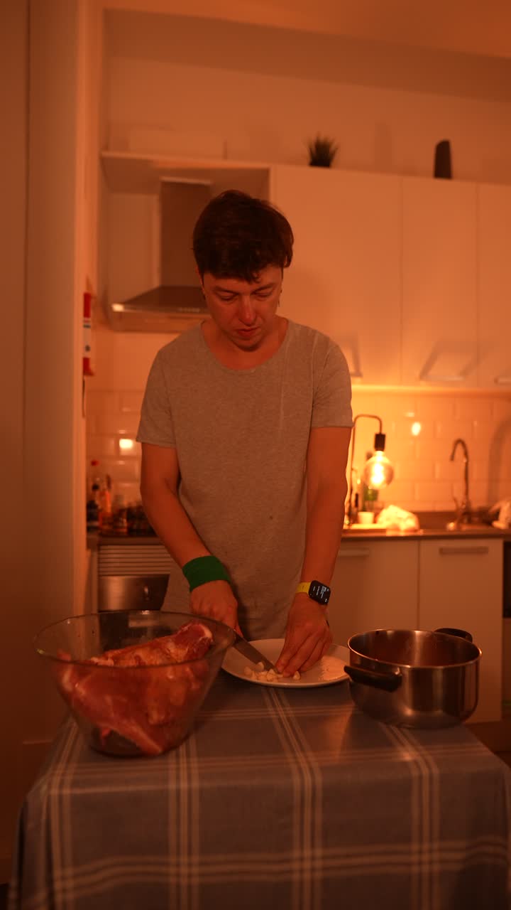 Person Chopping Meat and Vegetables in Kitchen
