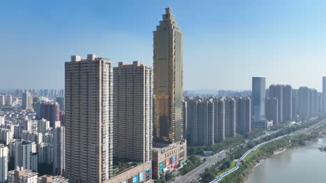 Urban-cityscape-Skyline-in-golden-sunset,-Skyscrapers-line-up-with-a-distinctive-supertall-building-at-business-financial-center