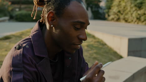 man sitting outside, taking notes