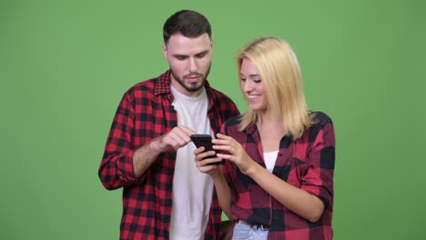 young couple using phone together