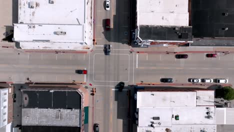 downtown geneseo, illinois intersection with cars and drone video looking down stable wide shot