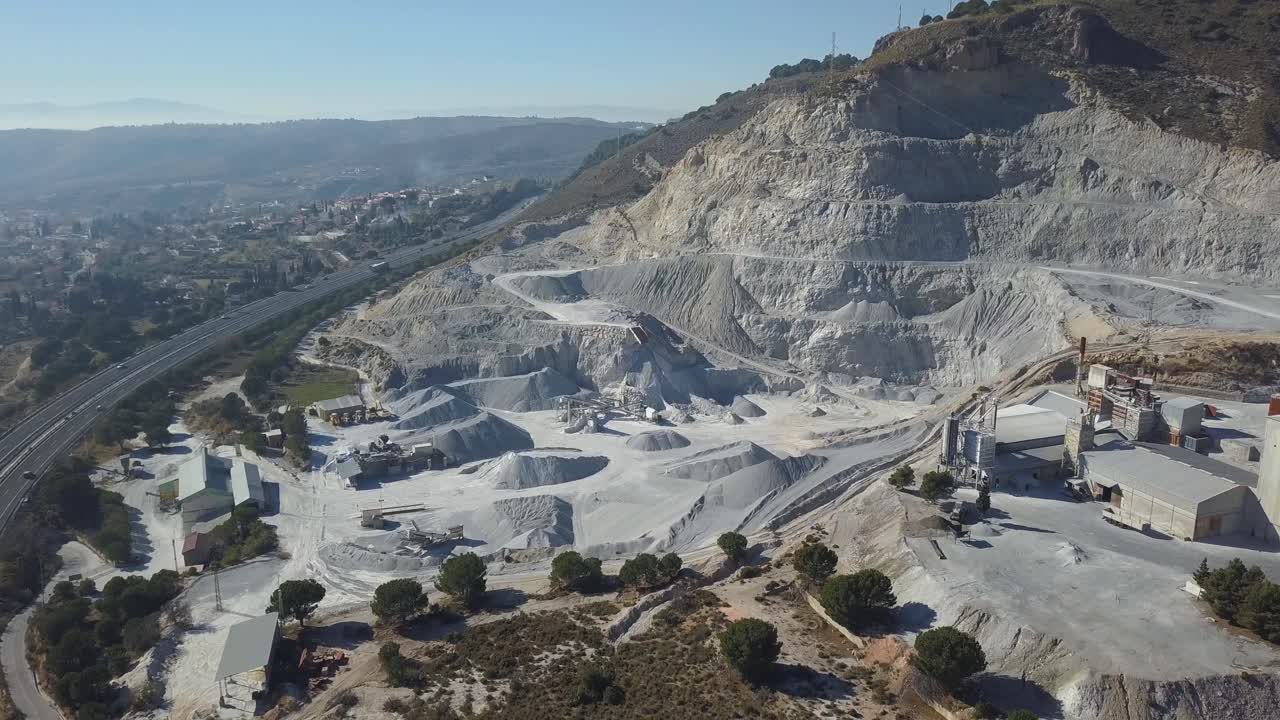 Aerial descending view of a big quarry in a mountain