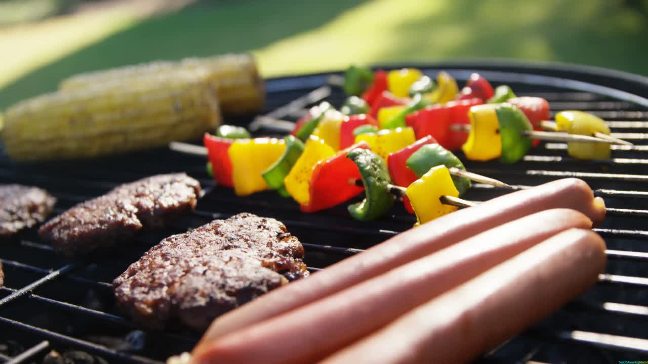 Corn, sausages and meat being grilled on barbecue 4k
