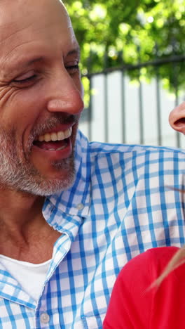 mature couple is sitting in the street and laughing