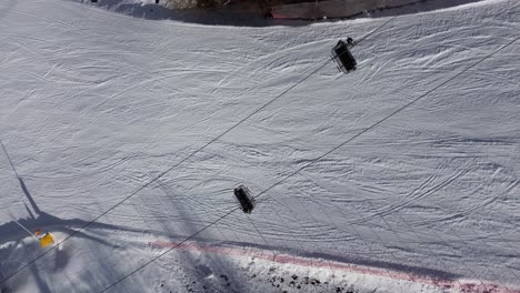 there are winter sports that play the role of the winter olympics in cortina and milano italy. learning to ski and snowboard i capture these videos with my drone that is in a ski resort. white color