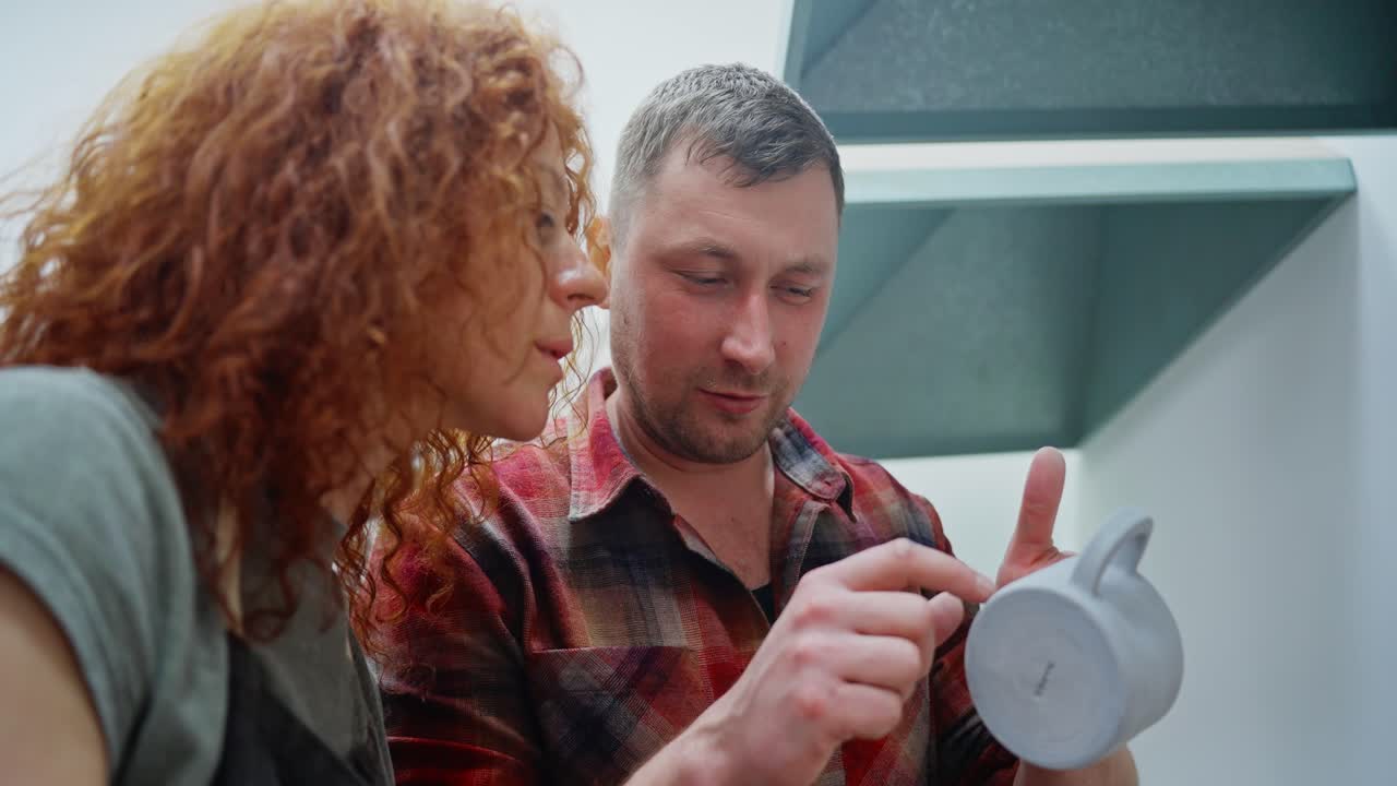 Pottery Workshop: Couple Inspecting a Ceramic Mug