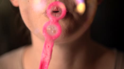 closeup macro slow motion lips blowing bubbles at camera