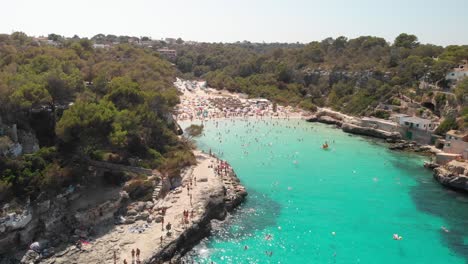 Spain-Mallorca-Cala-Llombards-and-Cala-Santanyi-at-4k-24fps-with-ND-filters-flying-with-a-DJI-Mavic-Air-with-beautiful-views-of-the-beaches,-rocks,-boats-and-blue-water