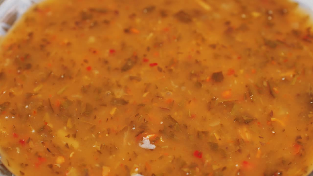 Close-up of a golden-orange soup or sauce