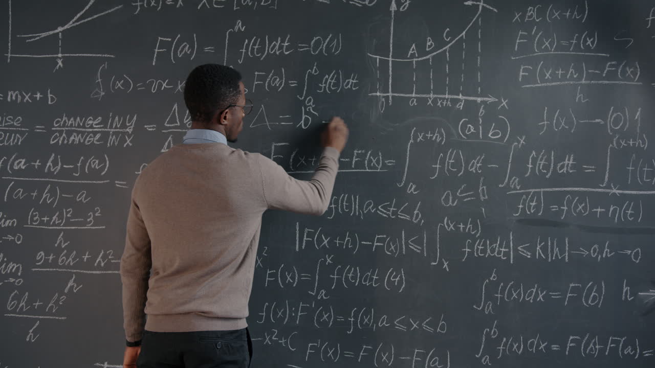 Professor Teaching Mathematics on Chalkboard