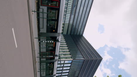 vertical view of light rail train on tracks near courthouse in amsterdam, the netherlands