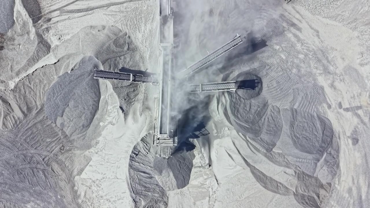 Quarry site with machinery and materials in action during daytime