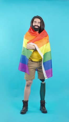 man with prosthetic leg holding pride flag