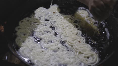 indian traditional sweet jalebi deep frying at hot refined oil