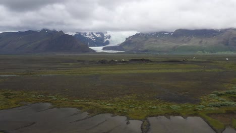 Two-parked-recreational-vehicles-near-glacier-in-Iceland-with-drone-video-moving-over