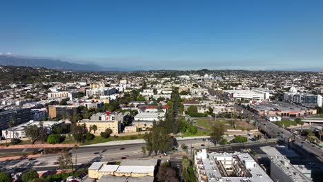 Aerial:-rising-view-over-Hollywood-suburb-in-Los-Angeles-USA,-sunny-day