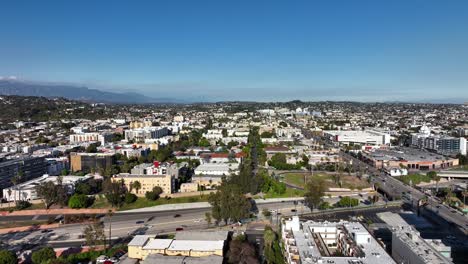 aerial: rising view over hollywood suburb in los angeles usa, sunny day