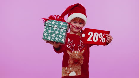 Toddler-girl-in-Christmas-hat-showing-gift-box-and-20-Percent-discount-inscriptions-banner-text-note