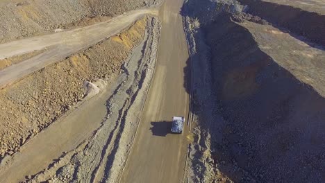 Heavy-machinery-working-in-te-riotinto-open-pit-copper-mine-aerial-shot