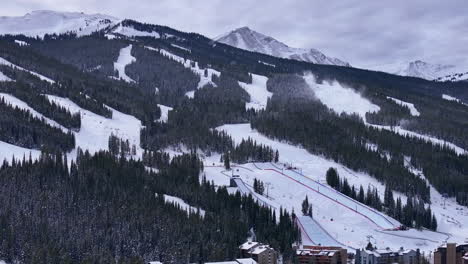 snow making half pipe big air jump ski snowboard gondola ski lift aerial drone cinematic copper mountain base colorado winter december christmas ski runs trails landscape rocky mountains circle left