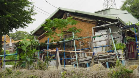 old brick house with pipes and plants, showing traditional chinese renovation work
