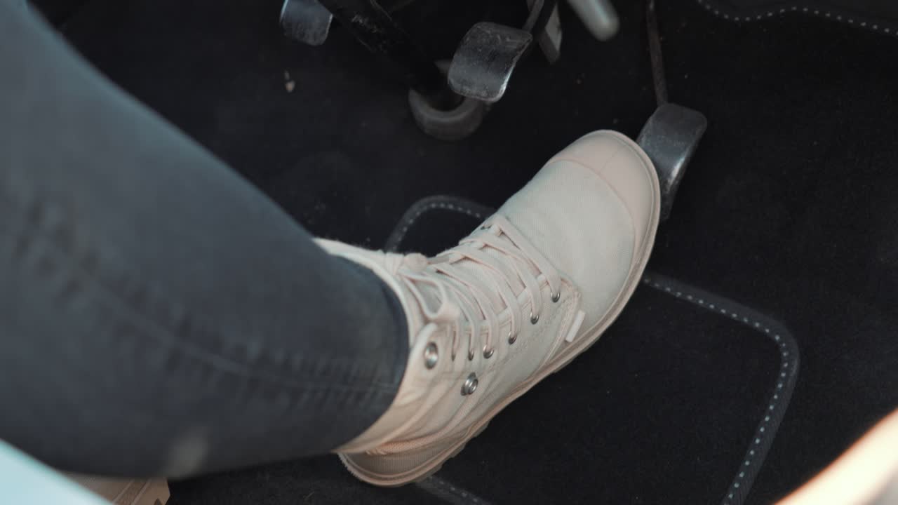 Person is pressing the gas and breaking pedal at of mythical French cars: a Citro&euml;n 2CV