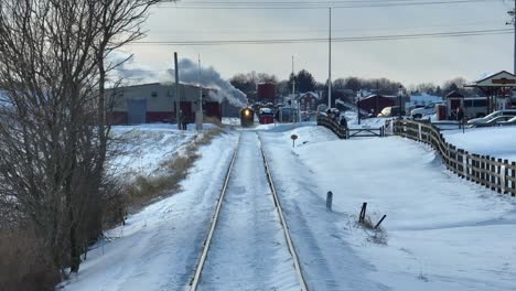 Head-on-aerial-view-of-a-train-at-a-vehicle-crossing