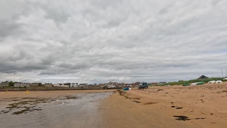 surfer walks along the sandy beach