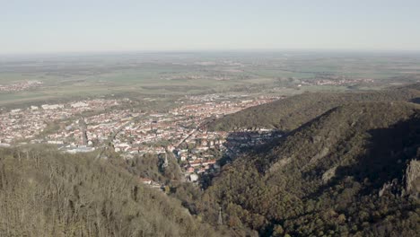 Drone-Aerial-view-of-Thale,-the-Rosstrappen,-Hexenstieg,-Hexentanzplatz-and-the-Bodetal-in-the-north-of-the-Harz-national-Park-in-late-autumn-at-sunset,-Germany,-Europe