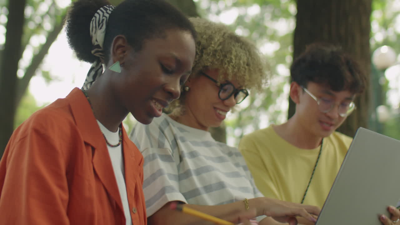 High School Students Using Laptop in Park