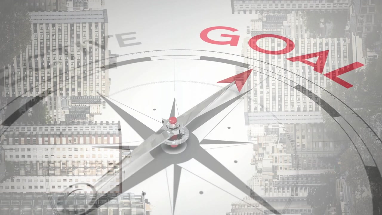 再生中、ビジネスシーンで金属製のコンパスが回転し、赤い針が「OBJECTIVE」を「GOAL」に合わせていく。