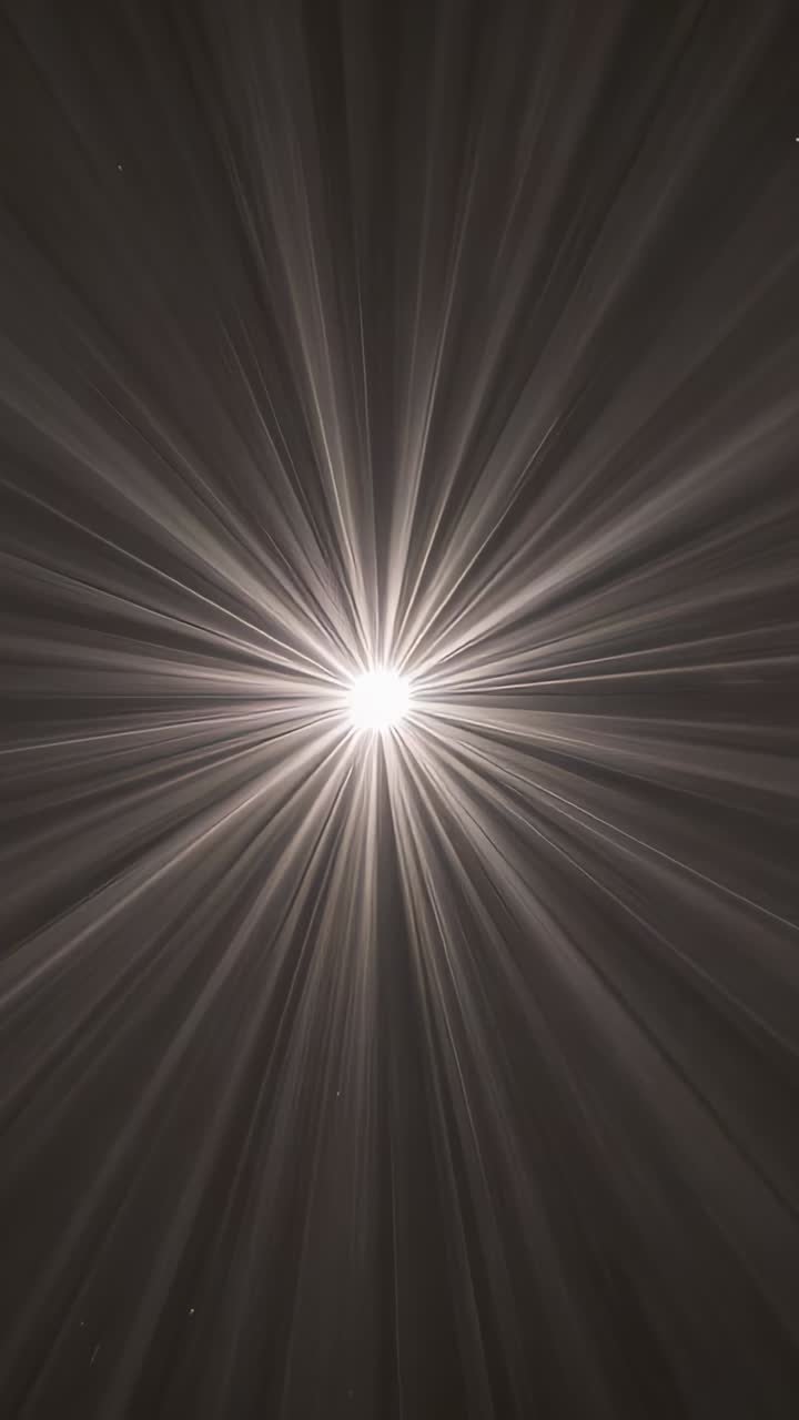 Vertical video: Camera capturing central bright light sending widening rays at dark ceiling in haze
