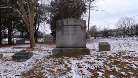 drone flying away from a grave marked yearwood in a small rural cemetery after a snow outside murfreesboro rutherford county tennessee