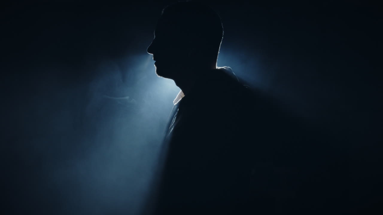 European Male Silhouette Profile Portrait in studio blue cool Light smoke detail