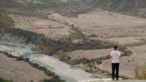 vjose river running next to autumn trees at sunrise on a road trip of albania