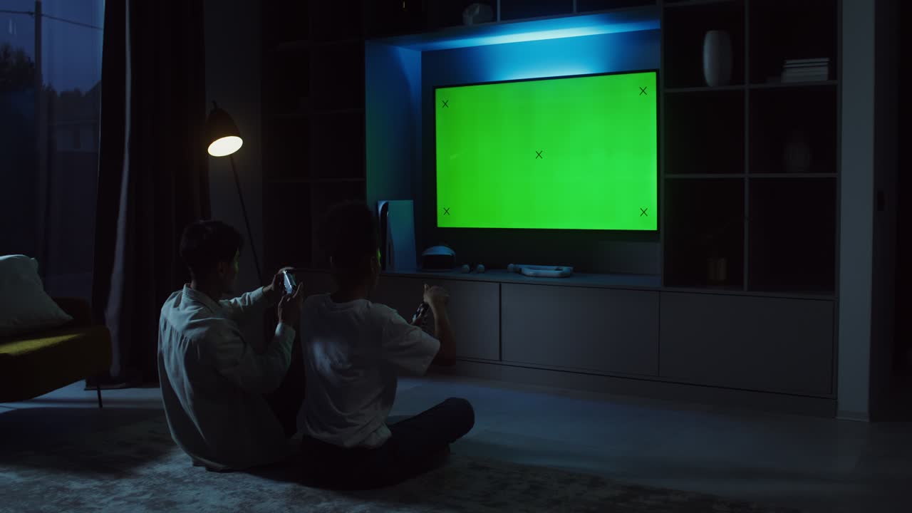 People watching television in living room