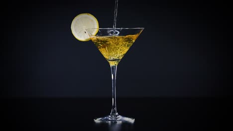 lime juice being poured into a cocktail glass