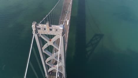 aerial shot of vehicles moving on san francisco–oakland bay bridge with city in background