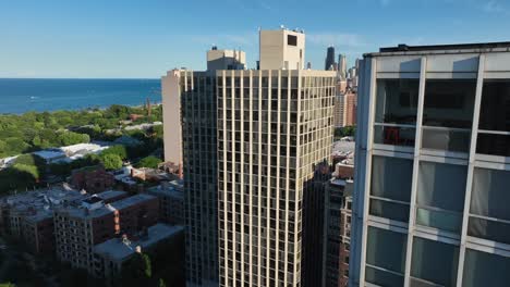 sweeping aerial shot around residential skyscraper north of downtown chicago