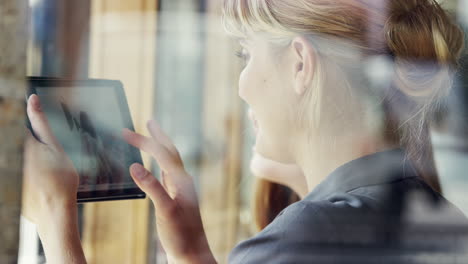 Beautiful-woman-using-digital-tablet-display-ipad-touchscreen-in-cafe