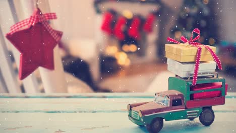 model car with presents on its roof and blurred background of a living room decorated for christmas