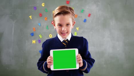 Schoolboy-showing-digital-tablet-in-classroom