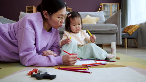 asian mother playing with her baby