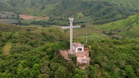 Aerial-zoom-in-on-the-impressive-cross-monument-atop-the-hill-in-Tecalitlan