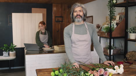 portrait of adult male florist in flower shop