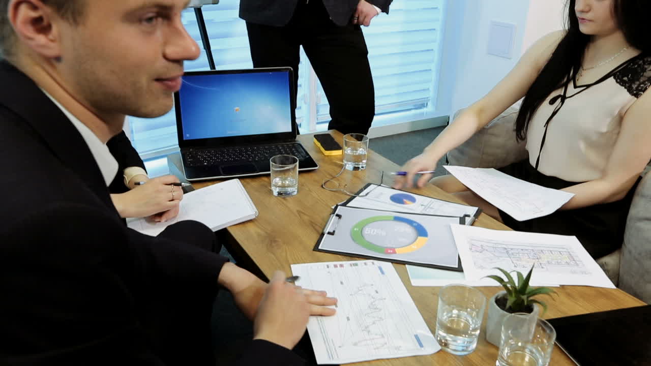 Working Process At Business Meeting. Young managers listening to his colleague explanations