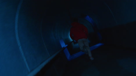 man running in underground tunnel and doing parkour stunt