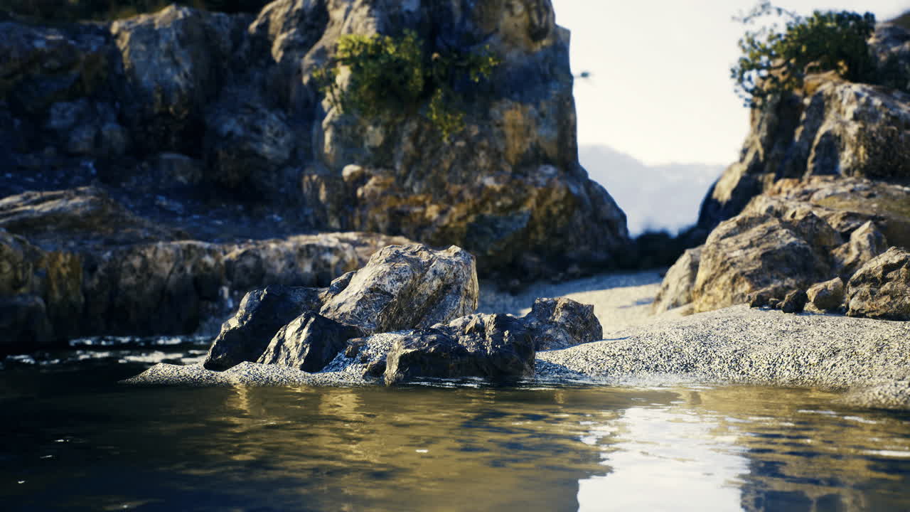 Serene waterfront with rocky landscape and gentle waters at sunrise