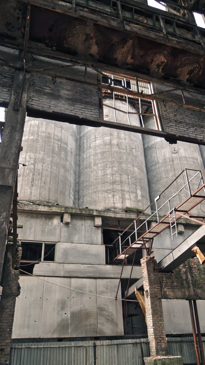 Ruins of an old factory. Interior of an abandoned derelict industrial structure. Vertical video