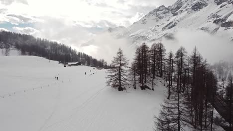 Aerial-panoramic-view-of-snow-capped-mountains-in-Valle-D'Aosta,-in-the-italian-alps,-in-winter